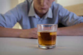 Young teen drinking whisky